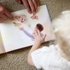 Ein Kind und Vater schauen sich das innere ihres personalisierten Buch für Väter und Töchter an.  