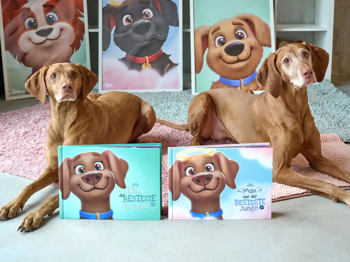 Zwei Vizsla-Hunde neben den personalisierten Hundebüchern „Ella das BESTESTE Mädchen“ und „Max war der BESTESTE Junge“ mit passenden Porträts im Hintergrund – ein einzigartiges Andenken für Haustierliebhaber.