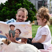 Dad and toddler reading When Holden Grows Up